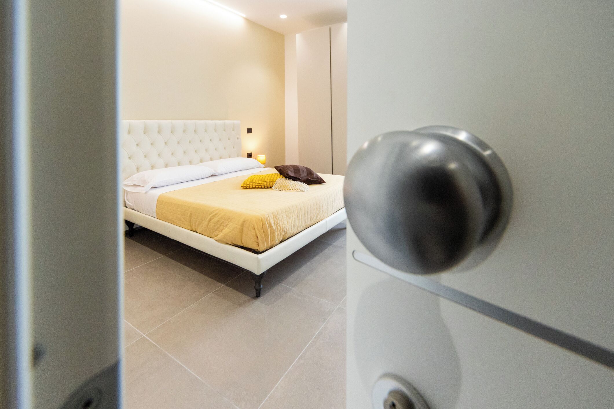 A bedroom with a bed, a bedside table, and a nightstand.