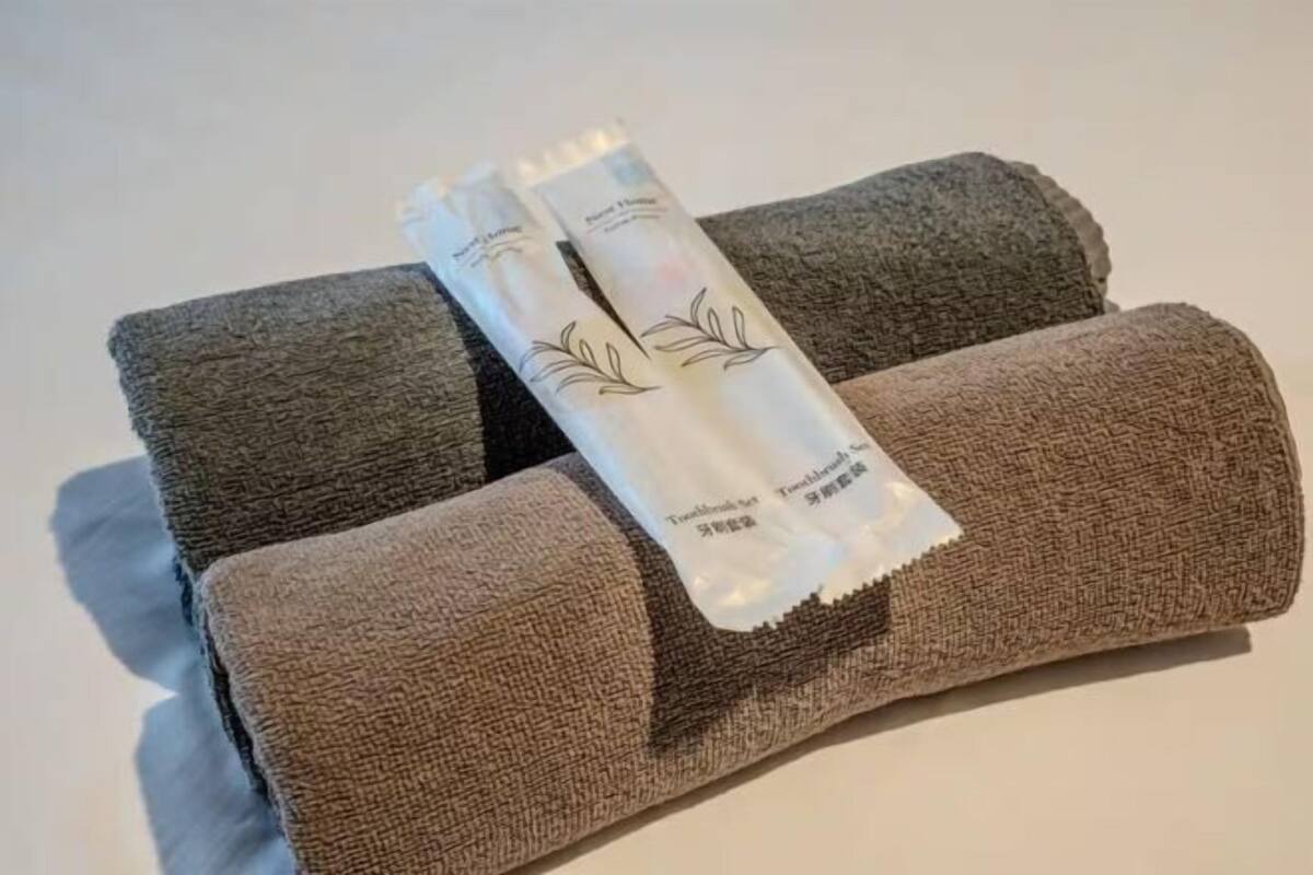 A towel and two tubes on a flat surface.