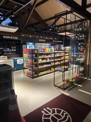 A grocery store with aisles labeled 'SORVETES,' 'BEBIDAS,' and 'FRI E LATICIÓNIS.' - Oka Beach Residence - Porto de Galinhas (Ipojuca)
