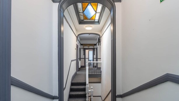 A narrow hallway with a staircase leading to a landing. - Room 2 - The Archers (Southampton)
