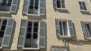 A multi-story building with multiple windows and balconies.