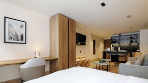 A hotel room with a bed, a desk, a chair, a kitchenette, and a dining area. - w Stylish Loft w/ Balcony in Parque Mexico (Mexico City)