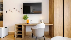 A modern office space with a desk, chair, television, and a small plant. - w Airy Loft W/balcony in Parque Mexico (Mexico City)