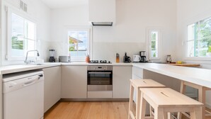A modern kitchen with a dishwasher, oven, and a long countertop. - Villa 'Herdain' with Mountain Views, Wi-Fi, and Air Conditioning (Mal Pas-Bon Aire)