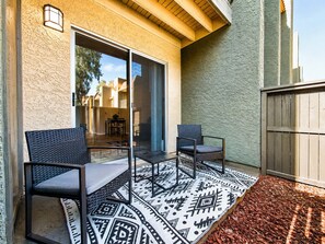 A patio with two chairs, a patterned rug, and a wooden fence. - Pool -Gym- Great for Mid/Long Stays (Mesa)