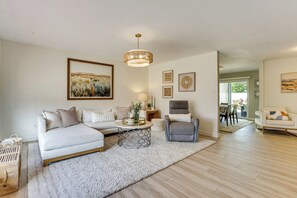 A modern living room with a sofa, armchair, coffee table, and artwork on the walls. - Great for Families! Desert Oasis 2 Mi to Old Town (Scottsdale)