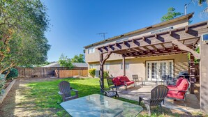 A backyard patio with a glass table, chairs, and a red sofa. - Family Gem w/ Pet-friendly Yard! 8 Mi to Riverside (Moreno Valley)