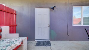 A door with a doormat, a red fence, and a window on a house. - 2 Mi to Dtwn Riverside & Hospital! Family Retreat (Riverside)