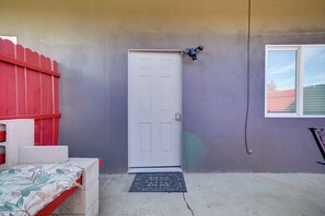 A door with a doormat, a red fence, and a window on a house. - 2 Mi to Dtwn Riverside & Hospital! Family Retreat (Riverside)