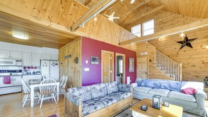 A wooden interior with a dining area, two sofas, a coffee table, and a staircase. - Family Friendly! Secluded Worcester Haven w/ Deck (Worcester)