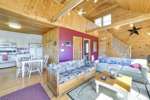 A wooden interior with a dining area, two sofas, a coffee table, and a staircase. - Family Friendly! Secluded Worcester Haven w/ Deck (Worcester)