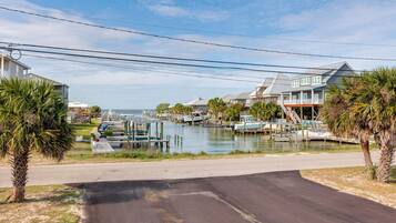 A marina with boats, waterfront houses, and a road leading to the water.