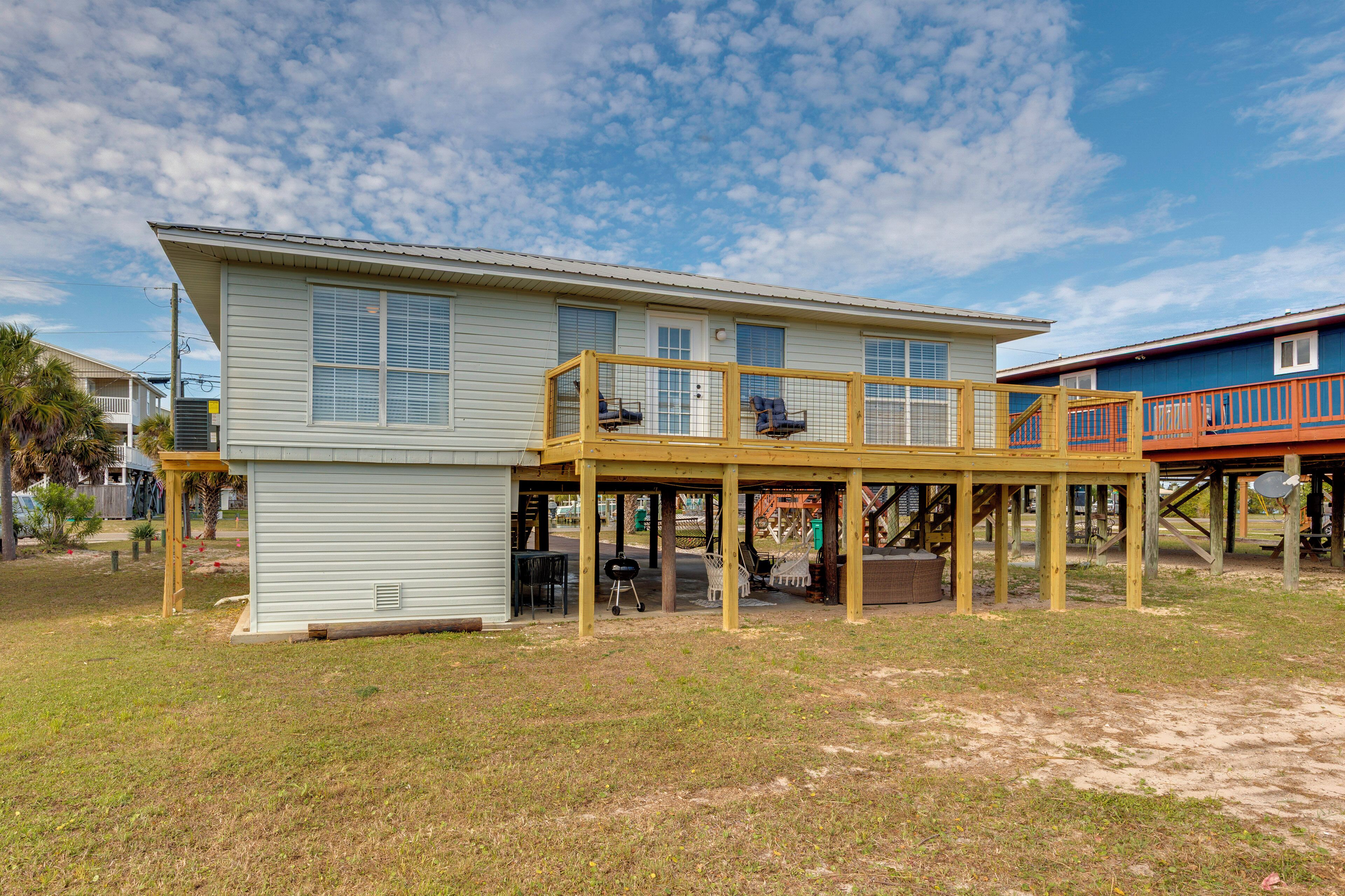 A two-story house with a covered patio area, a small porch, and a garage.