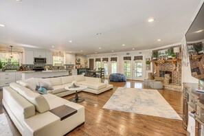 A spacious living area with a sectional sofa, a coffee table, and a fireplace.