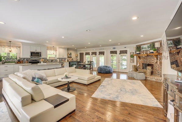 A spacious living area with a sectional sofa, a coffee table, and a fireplace.