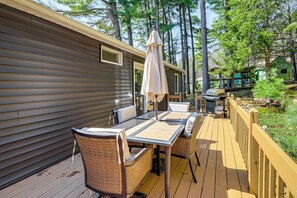A deck with a table and chairs, a covered umbrella, and a wooden fence. - 3 Mi to Lake George & Village: Family Home w/ Deck (Lake George)