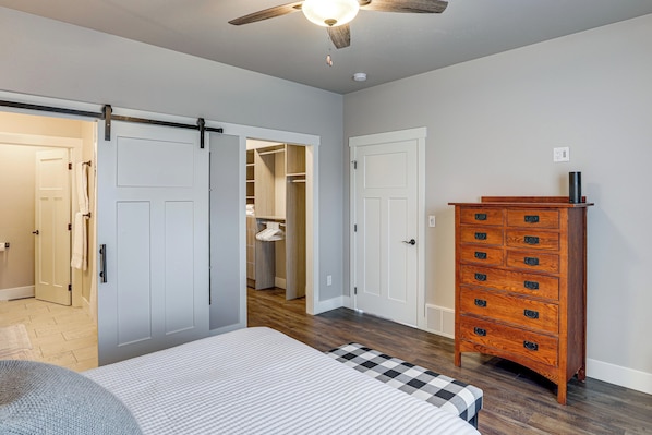 A bedroom with a bed, a dresser, a closet, and a ceiling fan. - Next to Public Golf Course! Kalispell Townhome (Kalispell)