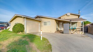 A single-story house with a garage, a covered porch, and a small attached shed. - Family-friendly Home 7 Mi to Dtwn San Bernardino! (Rialto)