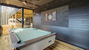 A pool table in a room with wooden flooring and a sloped ceiling. - Huge 3-unit Commerce Estate Near ATL Dragway! (Commerce)