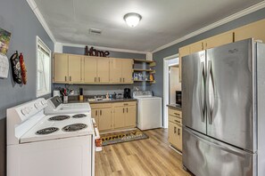 A kitchen with a stainless steel refrigerator, a stove, and a washer-dryer unit. - Great for Group & Work Stays! Decatur Unit By Dtwn (Decatur)