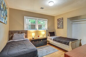 A bedroom with two beds, a dresser, a window, and a door. - Great for Group & Work Stays! Decatur Unit By Dtwn (Decatur)