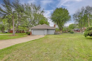 A residential property with a garage, a driveway, and a well-maintained lawn.