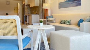 A modern hotel room with a sofa, armchair, round table, and a painting on the wall. - Fouka North Coast SA-5A-102 (Marsa Matrouh)
