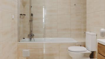 Bathtub, hair dryer, towels, soap