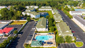 Un quartier résidentiel comprenant plusieurs maisons, une piscine et un parking.