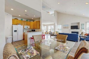 A modern apartment with a kitchen, dining area, and living room.