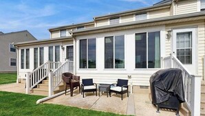 A covered patio area with outdoor furniture and a barbecue grill. - Taramino Spacious Townhouse w/shared pool, W/D & free WIFI (Lewes)
