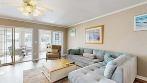 A living room with a sofa, a coffee table, and a ceiling fan. - Taramino Spacious Townhouse w/shared pool, W/D & free WIFI (Lewes)