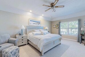 A bedroom with a bed, two bedside tables, a ceiling fan, a window with curtains, and a framed picture on the wall. - Light & bright home by great restaurants - 1.5 miles to downtown Rehoboth Beach (Rehoboth Beach)