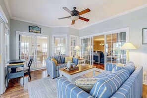 A living room with a sofa, a coffee table, and a ceiling fan. - Light & bright home by great restaurants - 1.5 miles to downtown Rehoboth Beach (Rehoboth Beach)