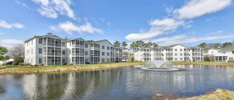 A modern apartment complex with a central courtyard and a fountain.