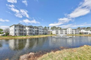 A modern apartment complex with a central courtyard and a fountain. - Stunning Condo- Pool and Hot Tub- Convenient Beach Access! (Rehoboth Beach)