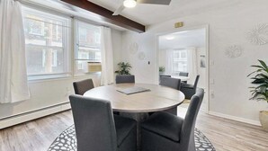 A conference room with a round table, six chairs, a ceiling fan, and a large mirror on the wall. - Dog-friendly Rehoboth Beach gem steps from beach & boardwalk with fast WiFi (Rehoboth Beach)