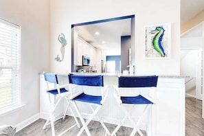 A modern kitchen with white cabinets, a blue countertop, and a microwave. - Dog-friendly townhome with pool, central AC, & W/D - only 1.5 miles the beach (Rehoboth Beach)