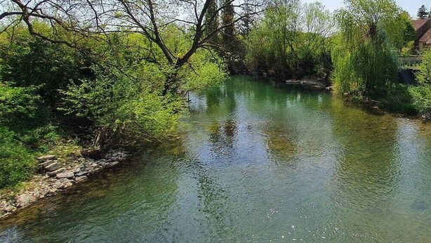 A clear river with surrounding greenery and buildings. - L'écrin de l'abreuvoir – Cozy Ground-Floor Retreat in Marnay Near Besançon (Marnay)