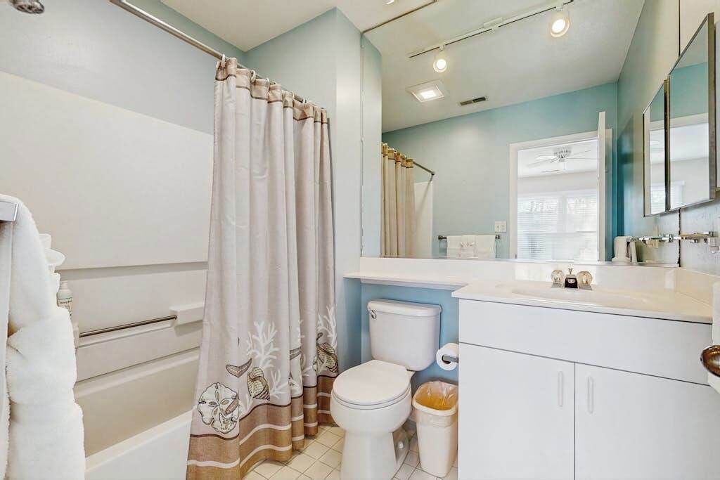 A bathroom with a bathtub, toilet, and sink.