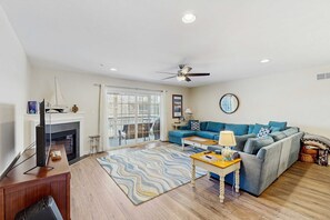 Ein Wohnzimmer mit Kamin, einer Couch, einem Couchtisch und einem Fernseher.