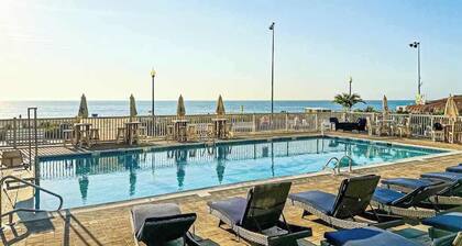 Condo near the beach with a pool, central AC, grill, & washer/dryer