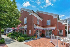 A brick building with a sign for '20 Baltimore Ave. Condominiums.' - Condo near the beach with a pool, central AC, grill, & washer/dryer (Rehoboth Beach)