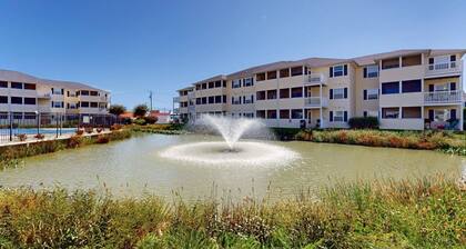 The Palms water-view condo near beach with outdoor pool, streaming, W/D, & AC