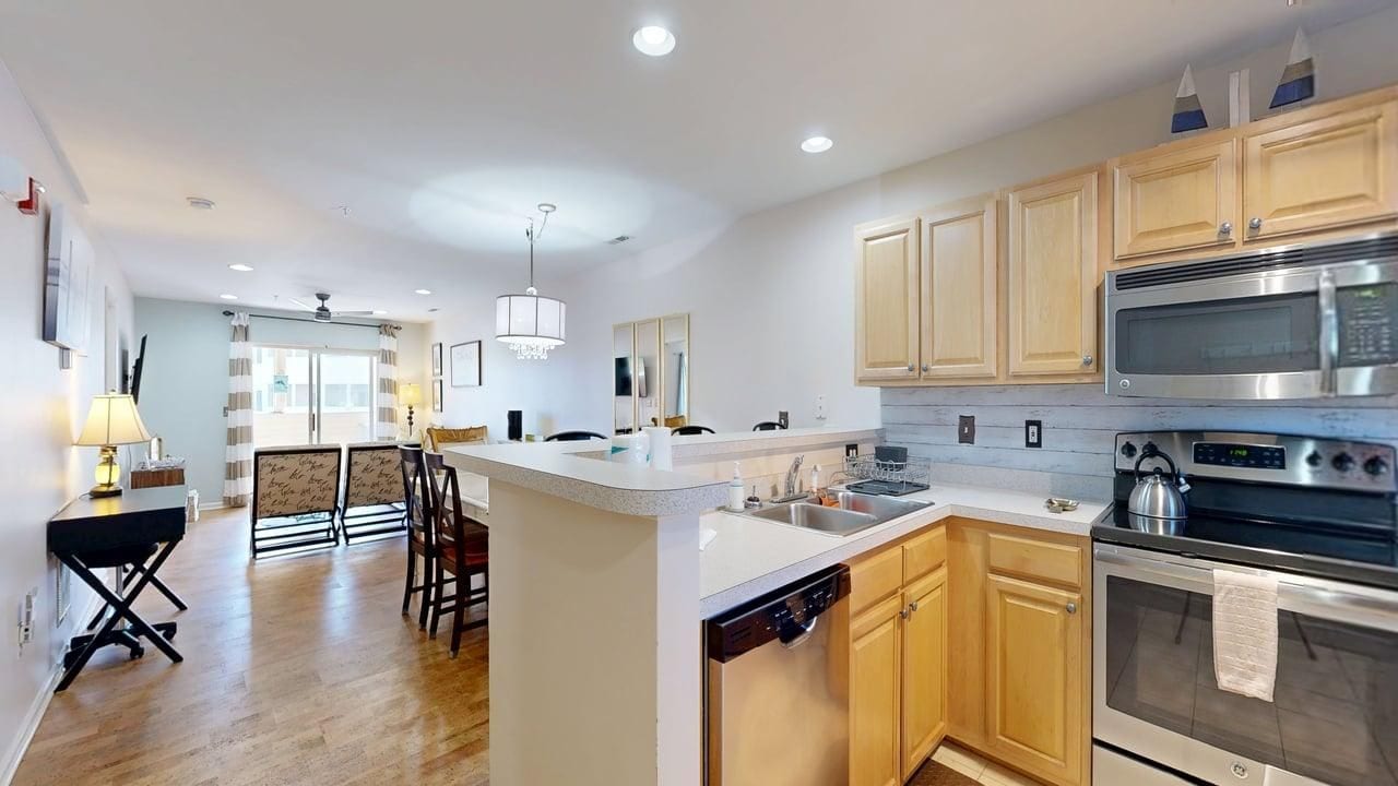 A modern kitchen with wooden cabinets, stainless steel appliances, and a central island.