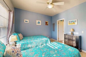 A bedroom with two beds, a ceiling fan, and a dresser. - Spacious Creekwood condo with shared pool, Balcony, W/D & Free WIFI (Rehoboth Beach)