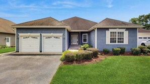 A two-story house with a garage, a front porch, and a well-maintained lawn. - Keys of Marsh Harbor house w/community pool & tennis court, deck, grill (Rehoboth Beach)