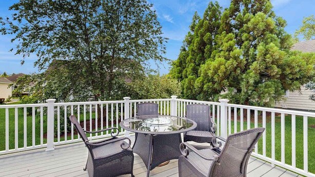 A deck with wicker furniture and a glass table, surrounded by a white railing. - Keys of Marsh Harbor house w/community pool & tennis court, deck, grill (Rehoboth Beach)