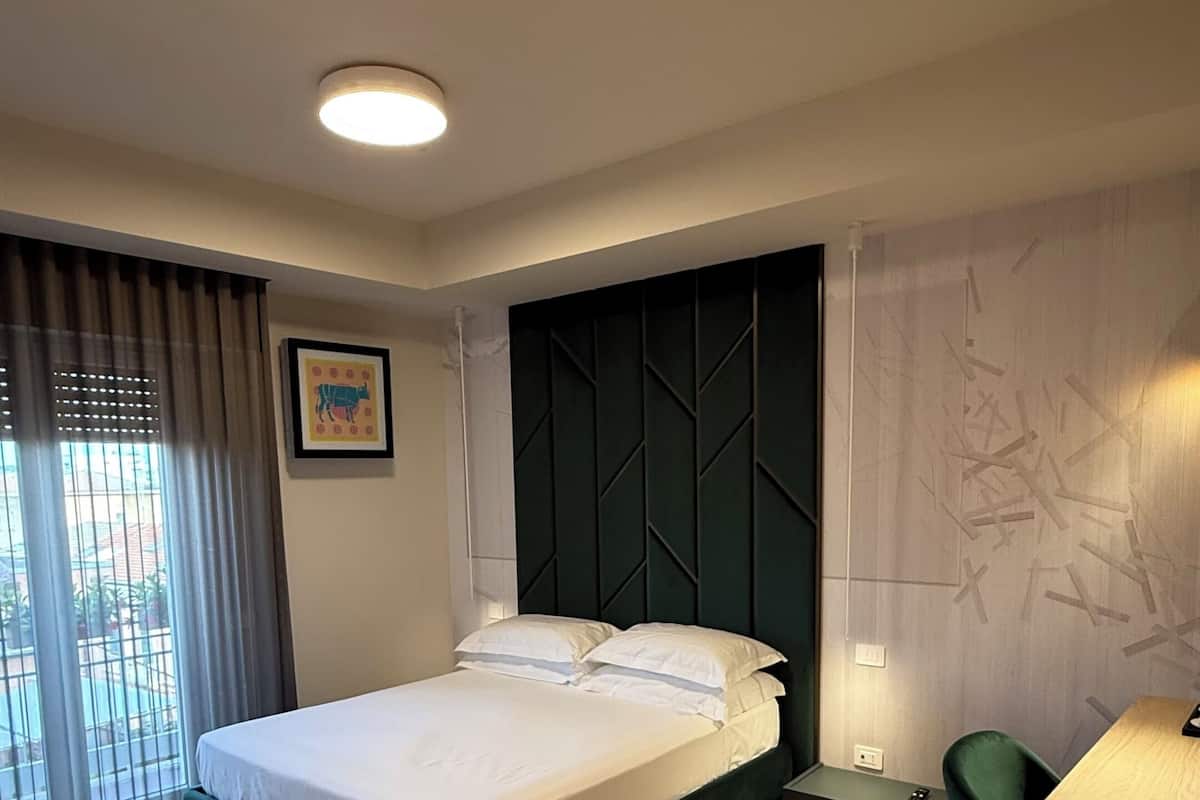 Deluxe Double Room, Balcony, Courtyard View | In-room safe, laptop workspace, blackout drapes, free WiFi