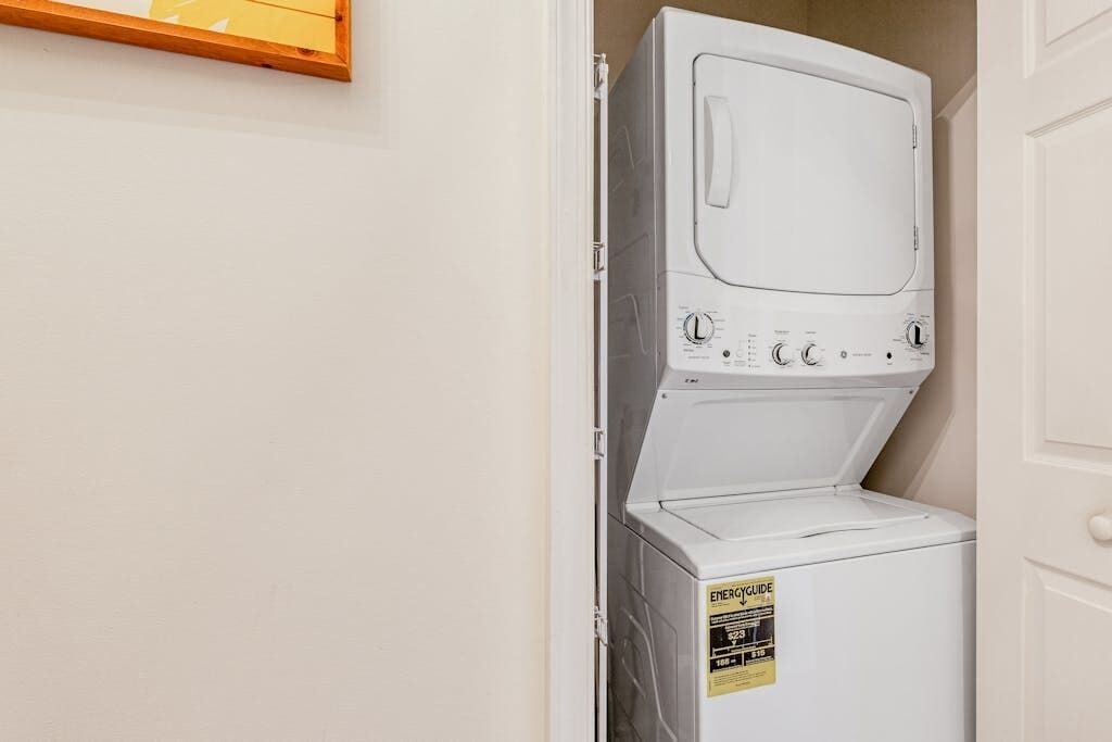 A white stacked washer and dryer unit with an ENERGY GUIDE label.
